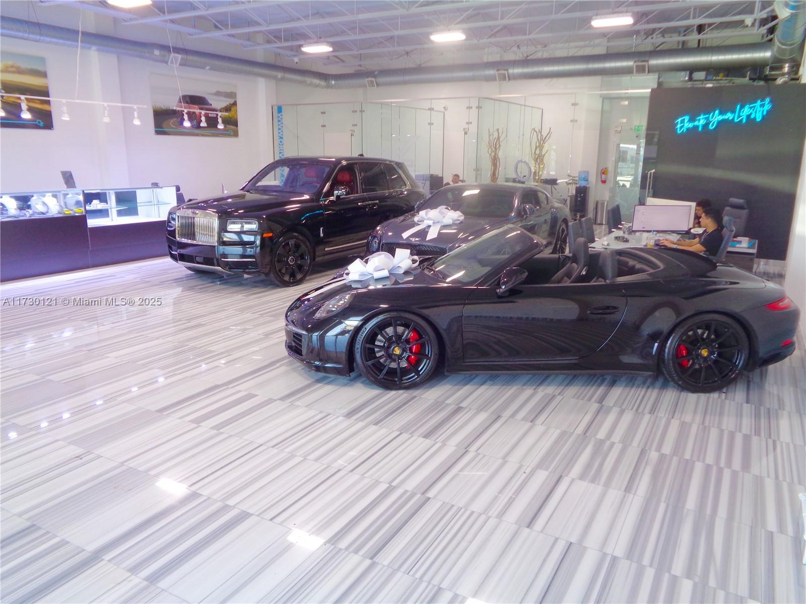 A car dealership showroom features luxury vehicles on a polished marble floor — 3749 N Federal Hwy, Pompano Beach FL 33064, POMPANO BEACH, FL