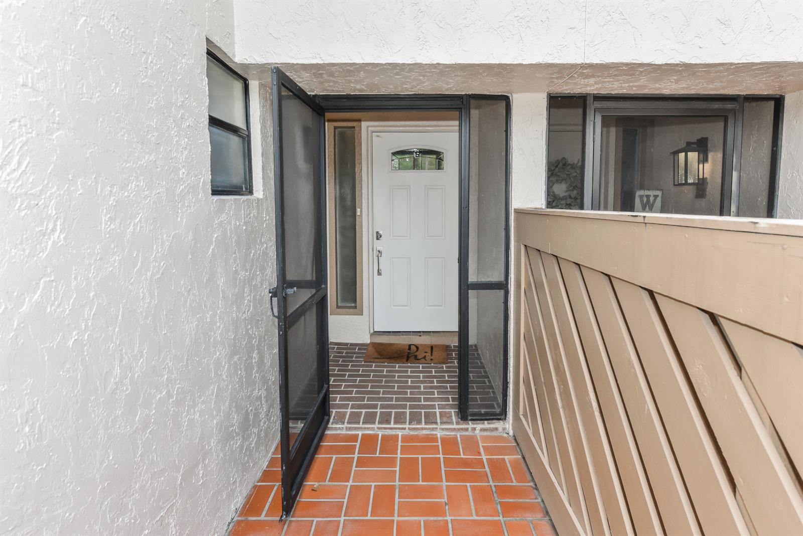 A kitchen features white cabinets, stainless steel appliances, gray subway tile, and marble-patterned countertops — 22904 Ironwedge Drive, Boca Raton FL 33433, BOCA RATON, FL