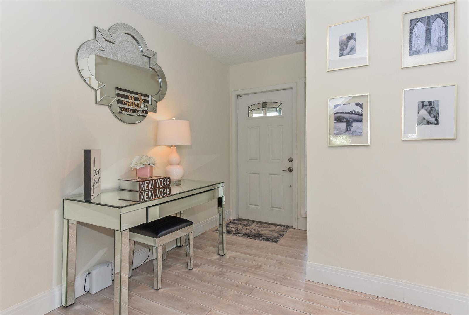 A kitchen with white cabinets, stainless steel appliances, gray subway tile, and marble-patterned countertops — 22904 Ironwedge Drive, Boca Raton FL 33433, BOCA RATON, FL