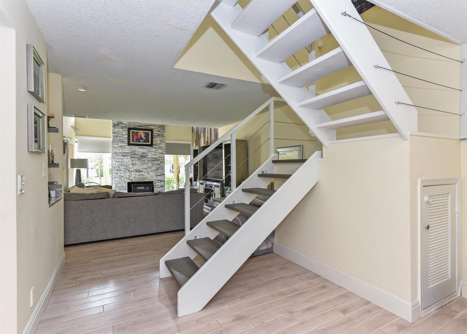 A kitchen features white cabinets, stainless steel appliances, gray subway tile, and marble-look countertops — 22904 Ironwedge Drive, Boca Raton FL 33433, BOCA RATON, FL