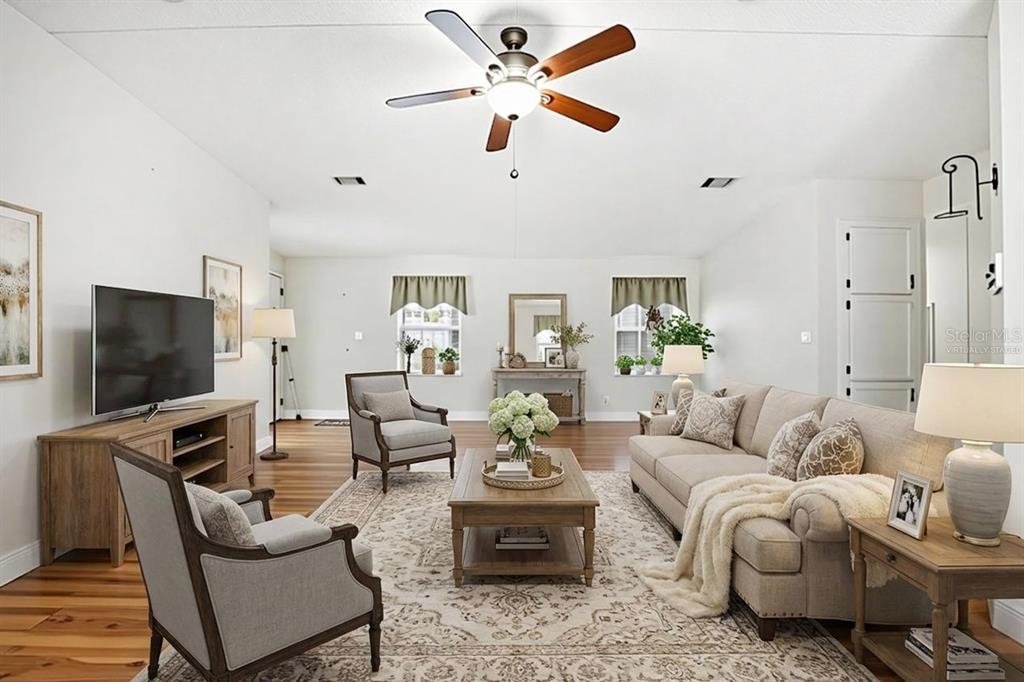 A living room features a sofa, two armchairs, a coffee table, and a ceiling fan — 324 CYPRESS RUN COURT, NORTH PORT, FL