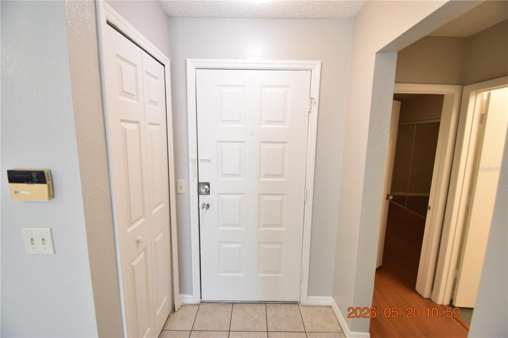 An entryway features a white front door, a closet with bifold doors, and tiled flooring — 12116 FELDWOOD CREEK LANE, RIVERVIEW, FL