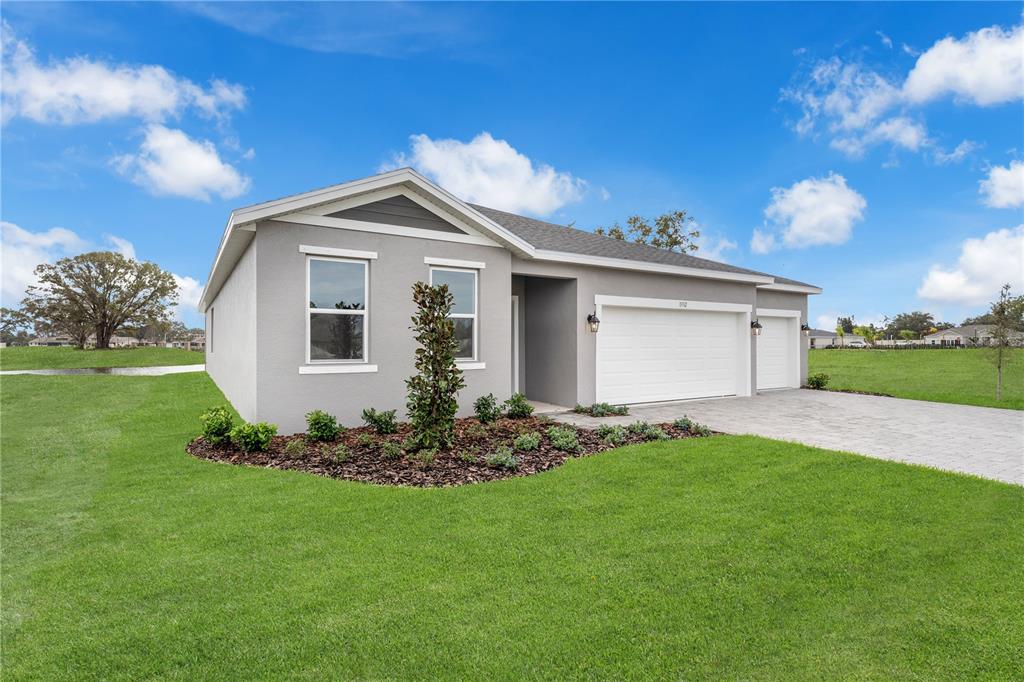 A single-story gray house with a two-car garage and a landscaped front yard — 1012 BANFF DRIVE NE, PALM BAY, FL