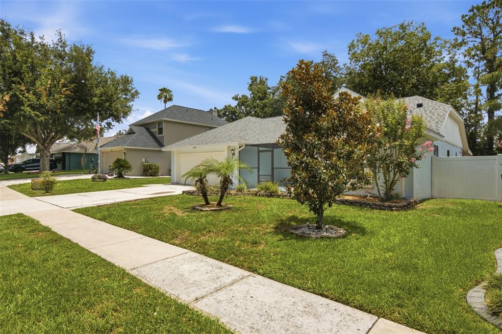 A single-story house with a light blue exterior, a two-car garage, and a front lawn — 2023 DARLINGTON OAK DRIVE, SEFFNER, FL