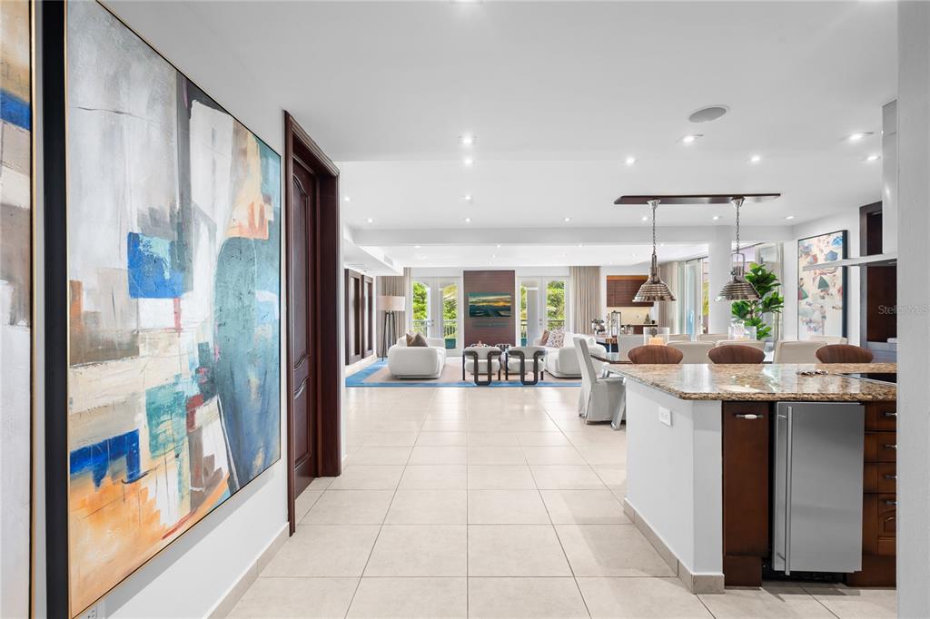 A view from a tiled hallway into an open-concept living and dining area — Palmas del Mar PLAZA DEL MAR UNIT N-3A, HUMACAO, PR