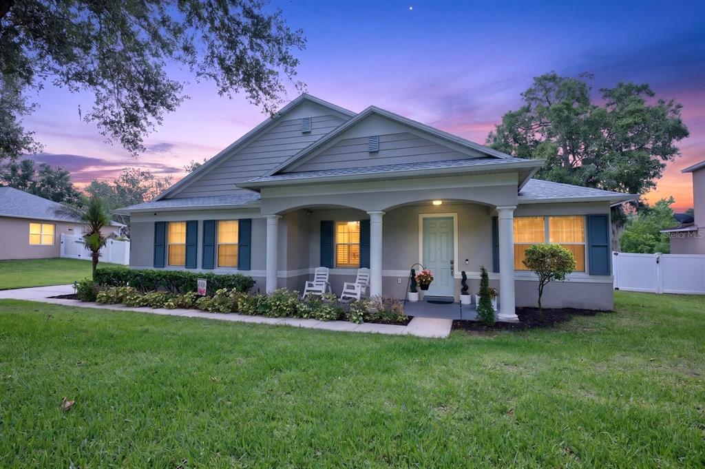 A single-story house with a covered front porch, columns, and a light-colored front door — 2550 BREEZY MEADOW ROAD, APOPKA, FL