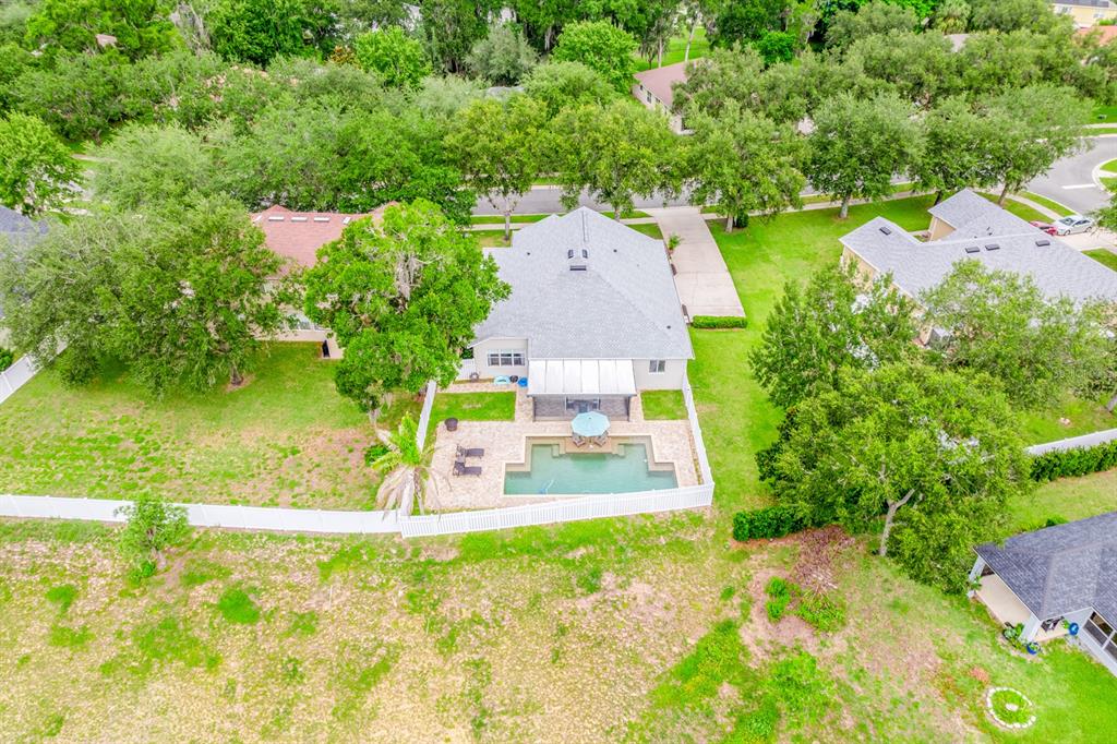 An aerial view shows a house with a backyard pool and patio enclosed by a fence — 2550 BREEZY MEADOW ROAD, APOPKA, FL