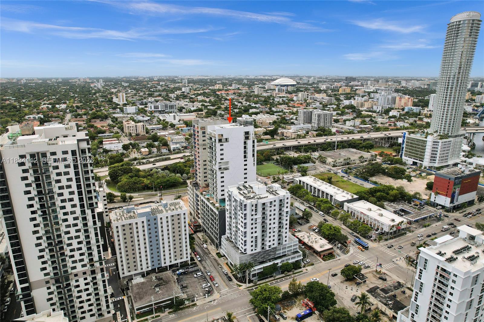 An aerial view of a city skyline featuring several modern high-rise apartment buildings — 239 SW 9th St # 2203, Miami FL 33130, MIAMI, FL