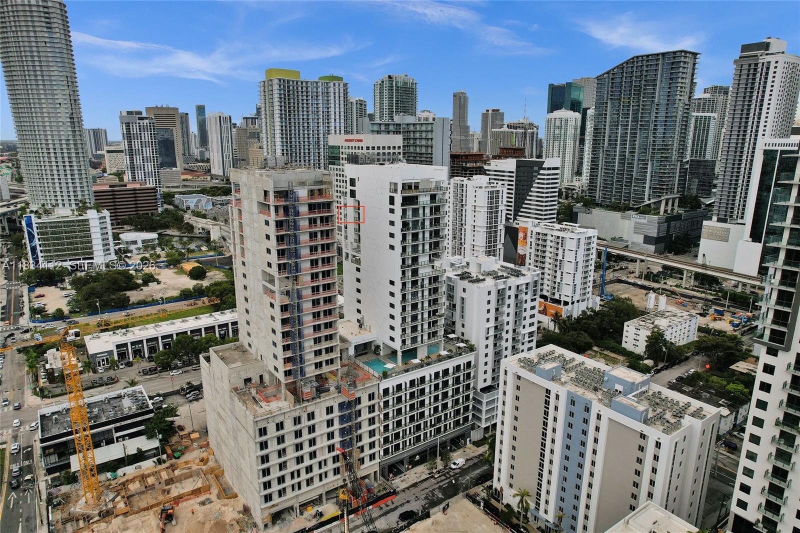 An aerial view shows a dense urban landscape featuring several high-rise buildings under construction — 239 SW 9th St # 2203, Miami FL 33130, MIAMI, FL