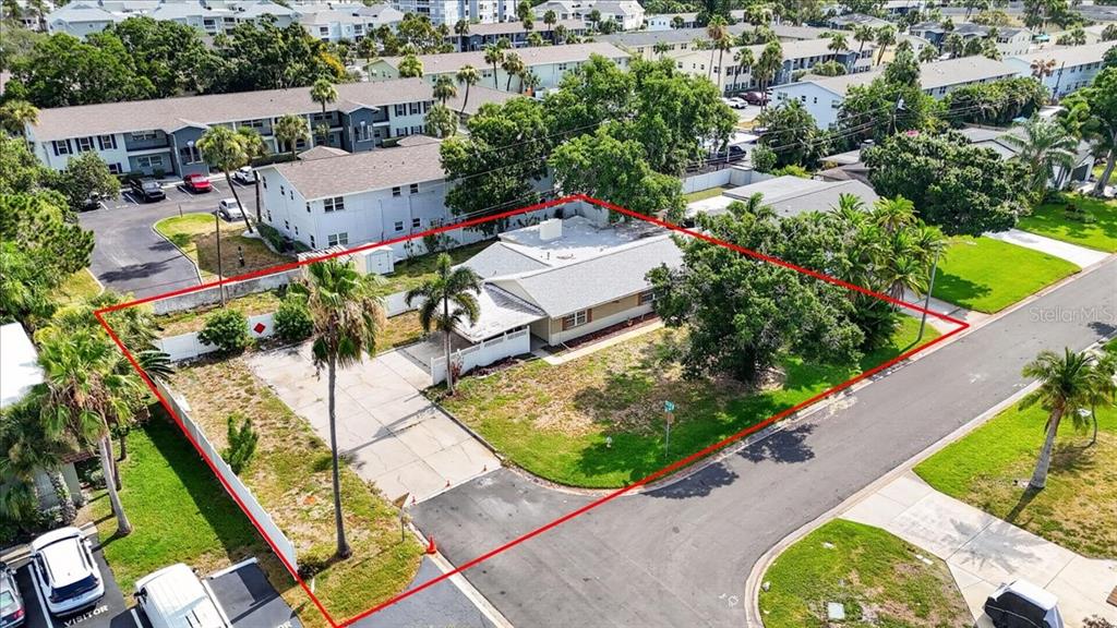 An aerial view shows a single-story house with a large yard enclosed by a red outline — 6999 16TH AVENUE N, ST PETERSBURG, FL
