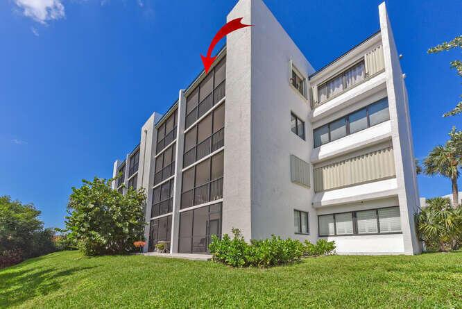 A multi-story residential building with screened balconies and white exterior walls under a blue sky — 1605 S Us Highway 1 # F401, Jupiter FL 33477, JUPITER, FL