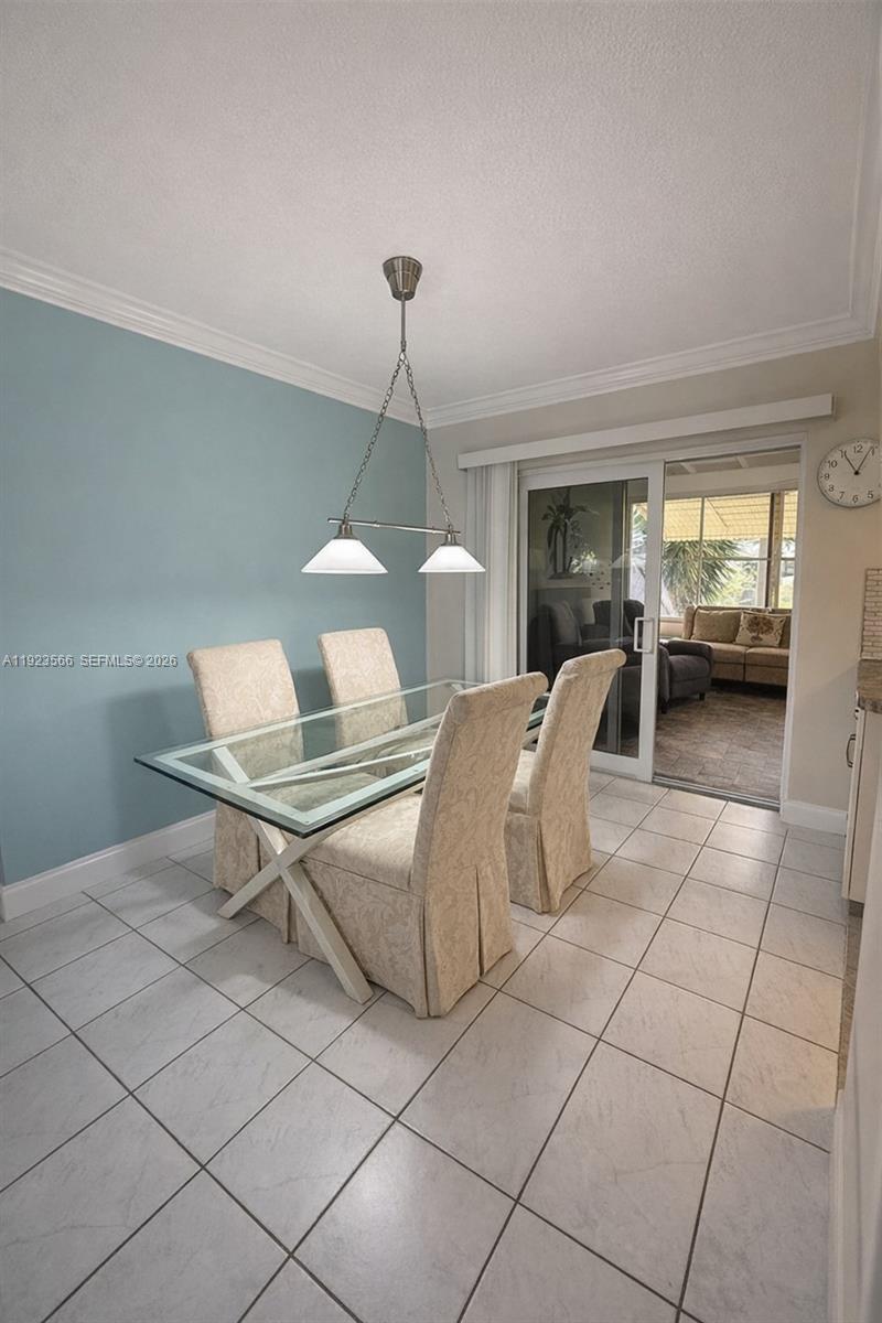 A dining area features a glass-top table, four upholstered chairs, and a light blue wall — 4208 NW 47th Ct, Tamarac FL 33319, TAMARAC, FL