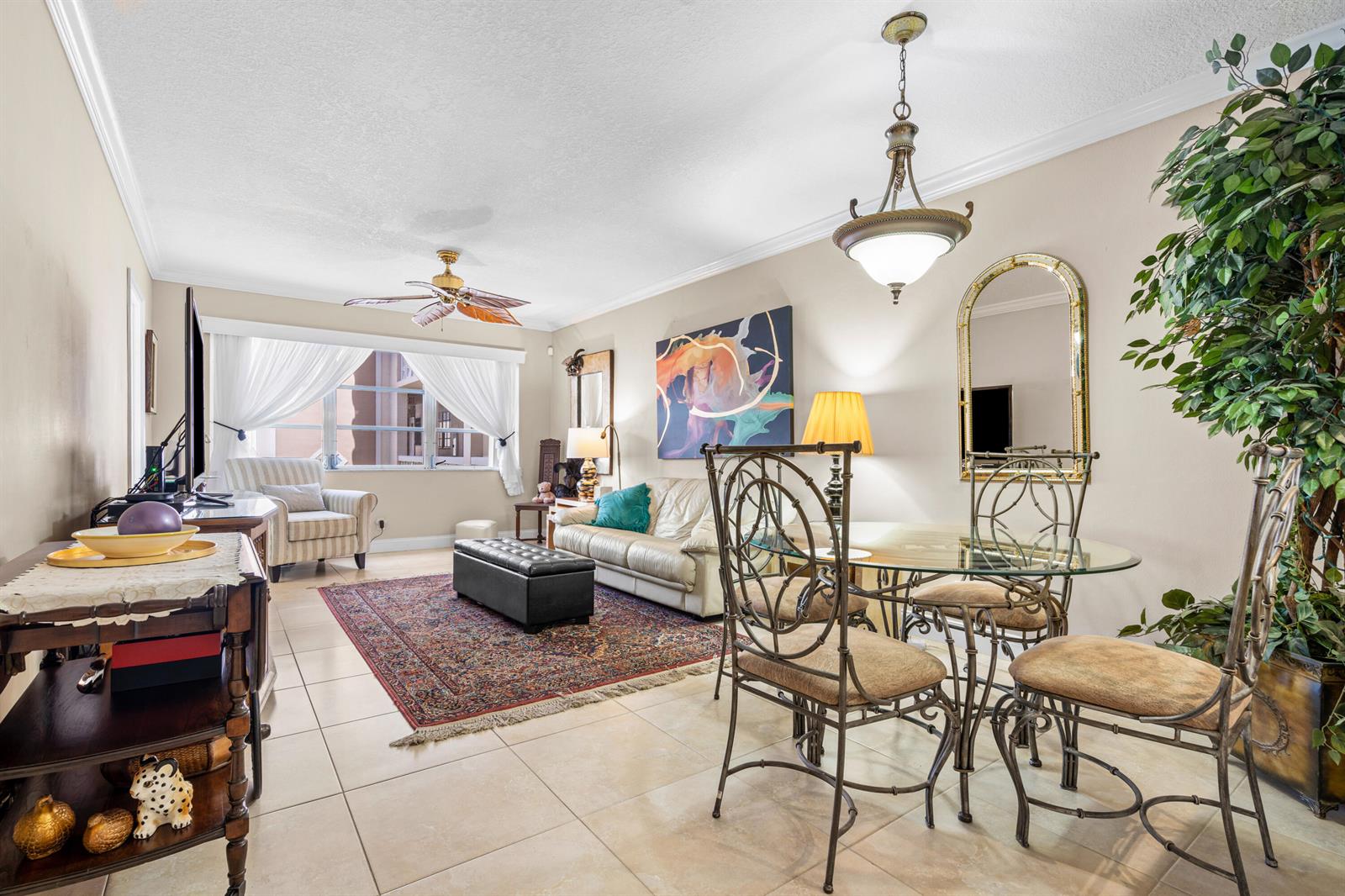 A living and dining room with tile floors, a glass table, and a patterned area rug — 400 NE 20th Street # B204, Boca Raton FL 33431, BOCA RATON, FL