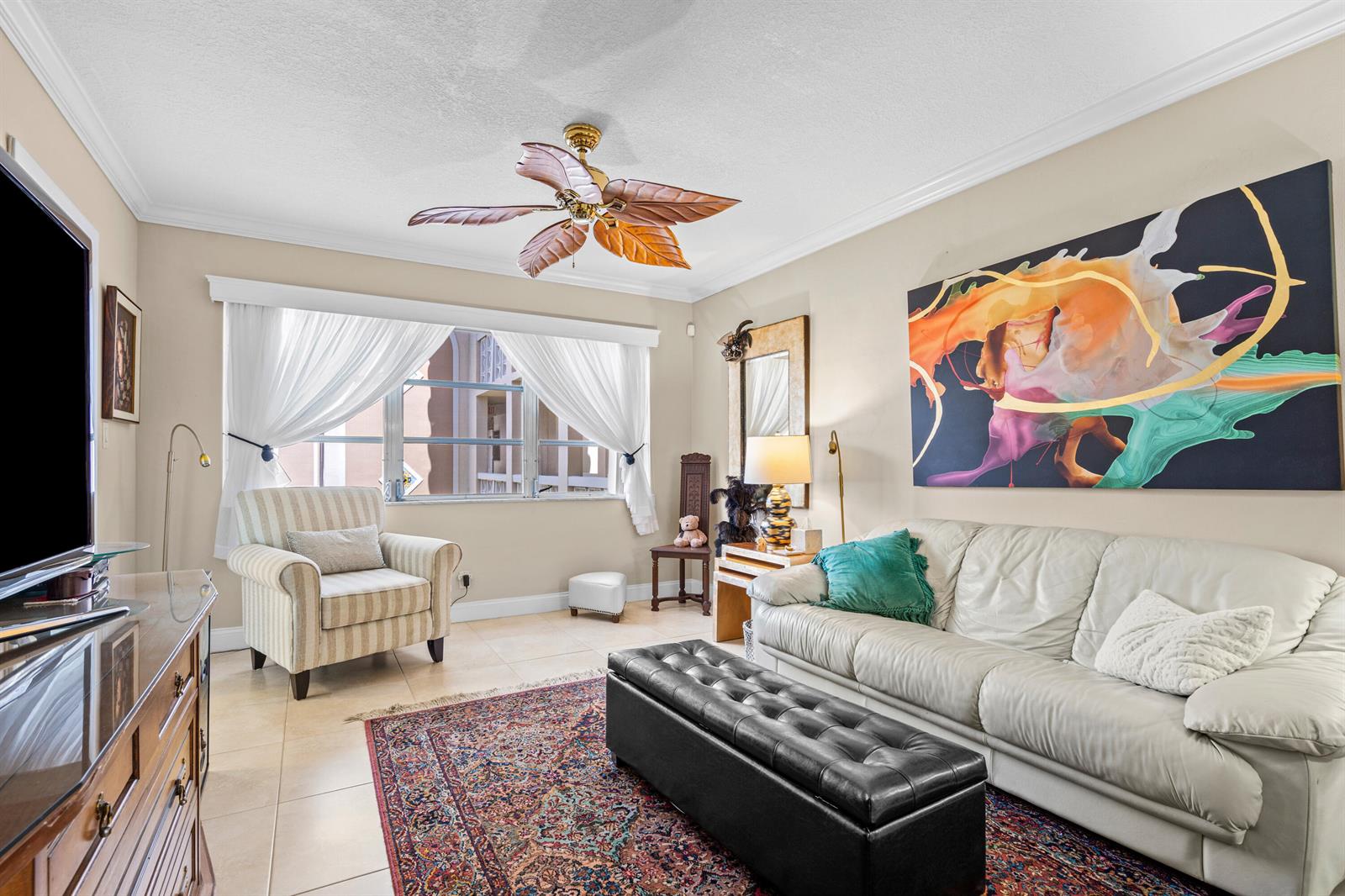 A living room features a white sofa, a striped armchair, a patterned rug, and a ceiling fan — 400 NE 20th Street # B204, Boca Raton FL 33431, BOCA RATON, FL