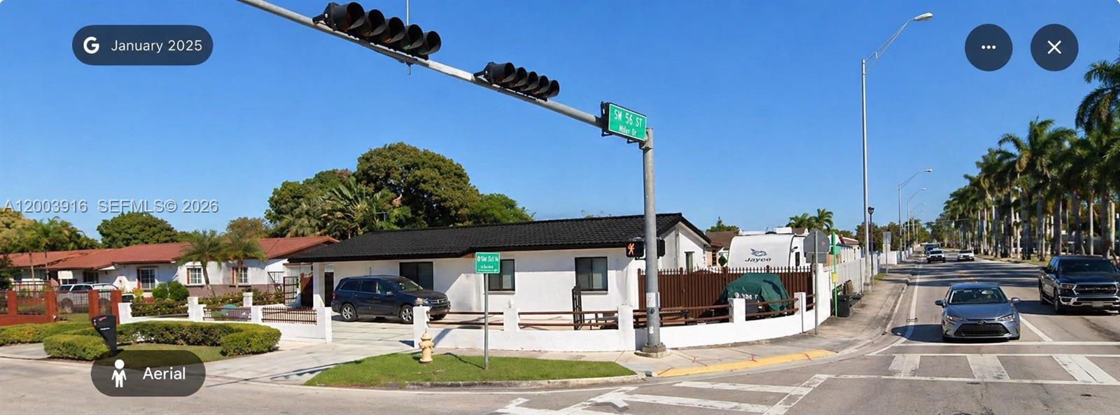 A white single-story house with a dark roof sits on a corner lot at an intersection — 5521 SW 132nd Ave, Miami FL 33175, MIAMI, FL