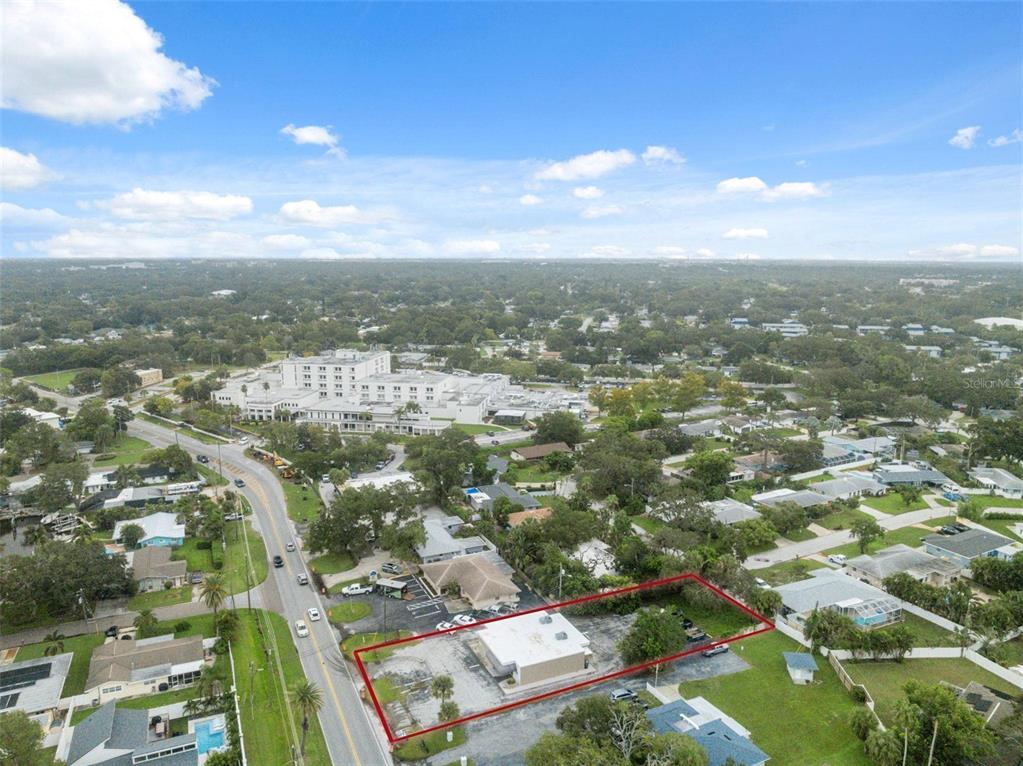 An aerial view shows a commercial building with a parking lot outlined in red — 2101 INDIAN ROCKS ROAD S, LARGO, FL