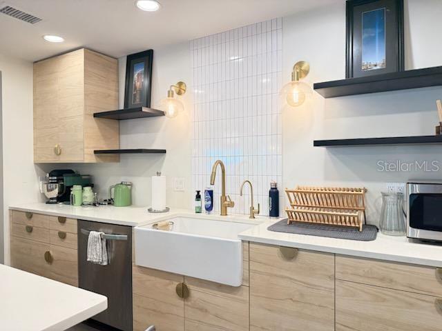A kitchen features light wood cabinets, a white farmhouse sink, gold fixtures, and black shelving — 1717 NW 23RD AVENUE UNIT GA, GAINESVILLE, FL