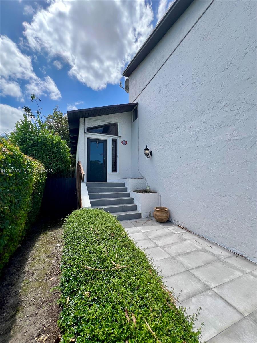 A paved walkway leads to a set of stairs and a front door entrance — 3610 SW 113th Pl, Miami FL 33165, MIAMI, FL