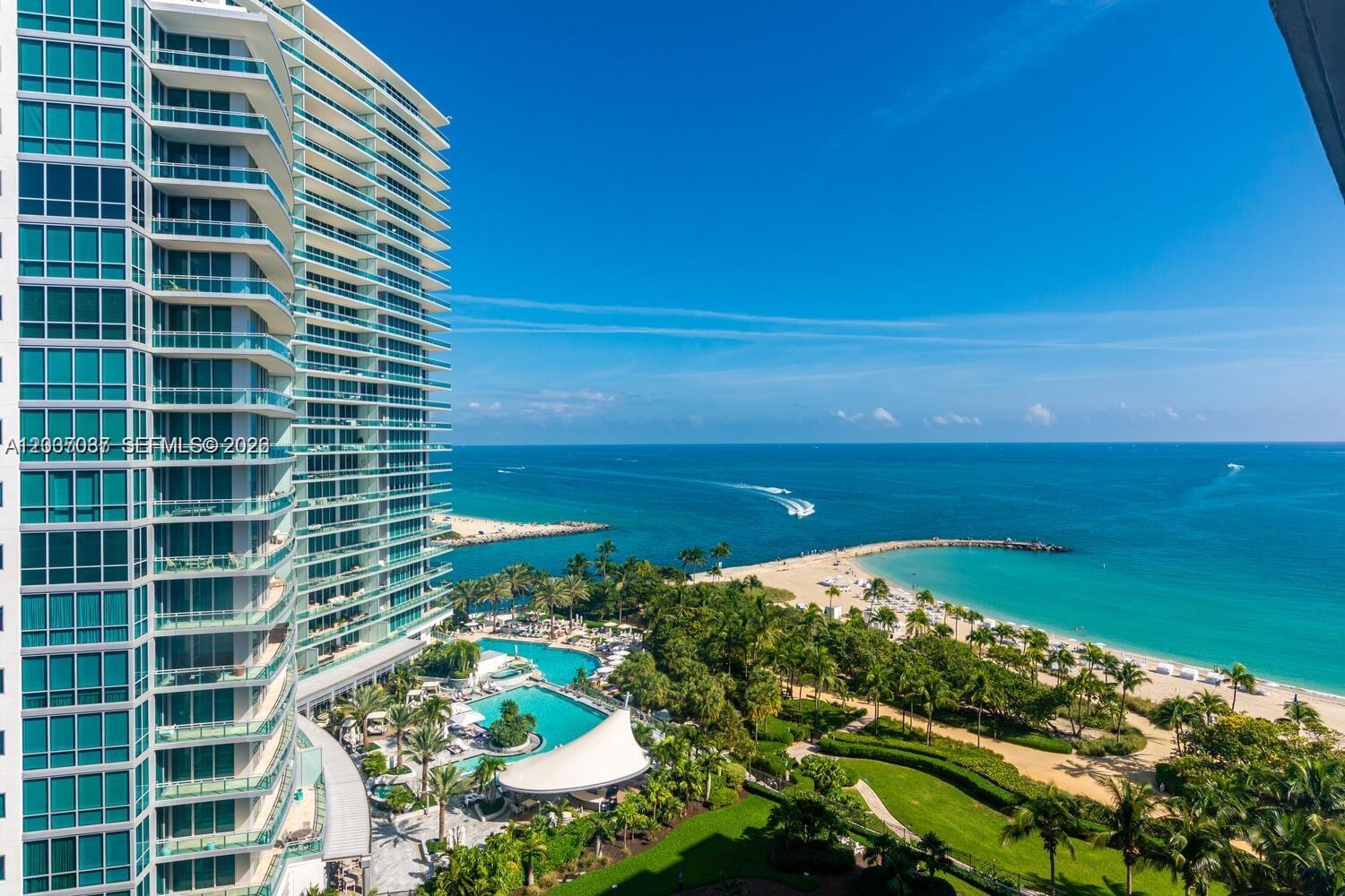 An aerial view shows a high-rise building next to a swimming pool and beach — 10275 Collins Ave # 1404, Bal Harbour FL 33154, BAL HARBOUR, FL