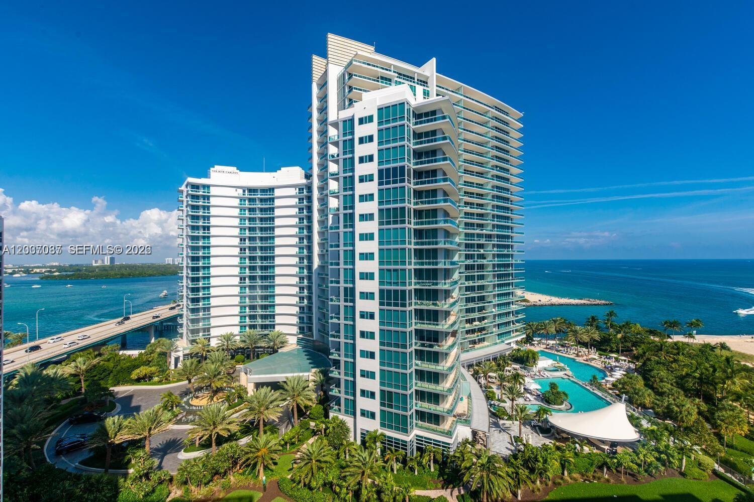 An aerial view shows a modern high-rise residential building with balconies overlooking the ocean — 10275 Collins Ave # 1404, Bal Harbour FL 33154, BAL HARBOUR, FL