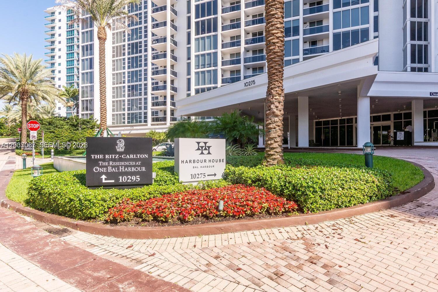 The exterior entrance of a residential building features signage for two different properties — 10275 Collins Ave # 1404, Bal Harbour FL 33154, BAL HARBOUR, FL