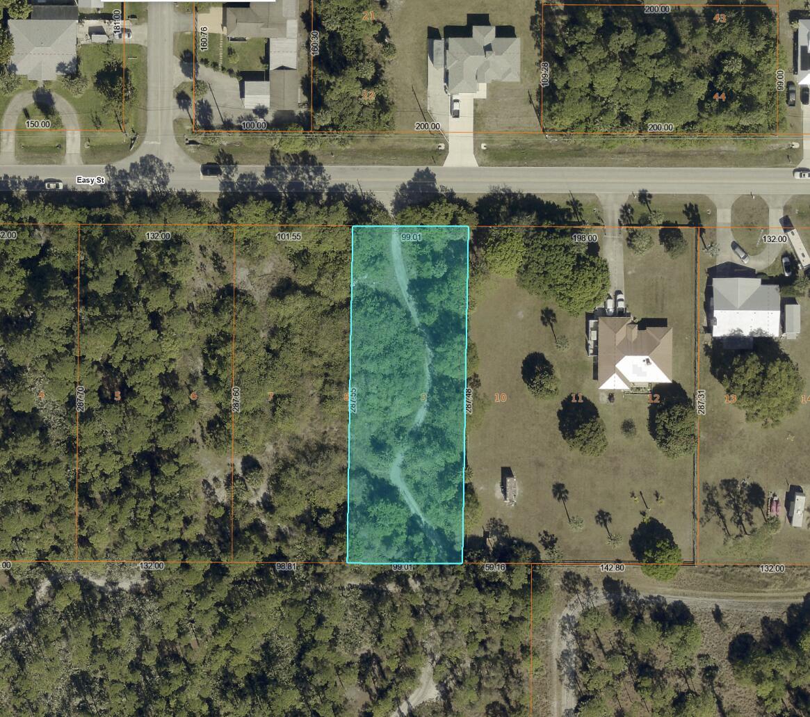This is an aerial map showing a rectangular, wooded parcel of land highlighted in blue — (0008) E Easy Street, Fort Pierce FL 34982, FORT PIERCE, FL