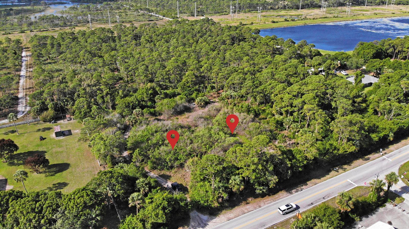 An aerial view shows two red location pins marking a wooded lot beside a road — (0008) E Easy Street, Fort Pierce FL 34982, FORT PIERCE, FL