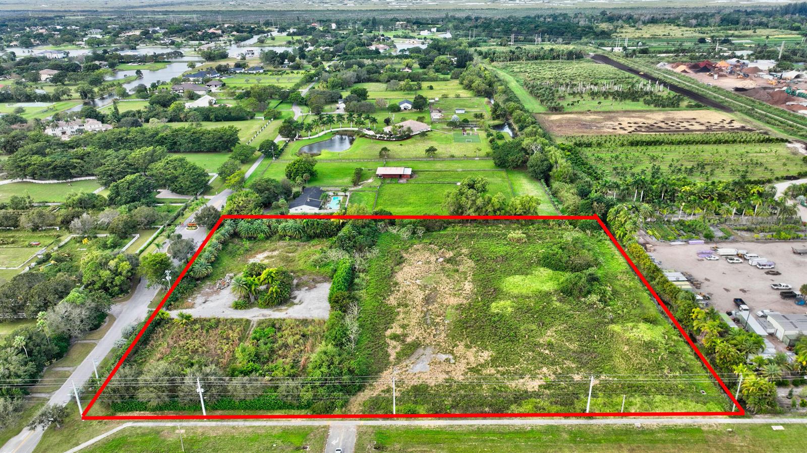 An aerial view shows a large, rectangular, undeveloped plot of land outlined in red — 15445 S State Road 7 Road, Delray Beach FL 33446, DELRAY BEACH, FL