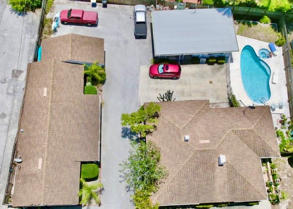 An aerial view shows two houses with a shared driveway, a pool, and several vehicles — 411 PLEASANT STREET, CLEARWATER, FL