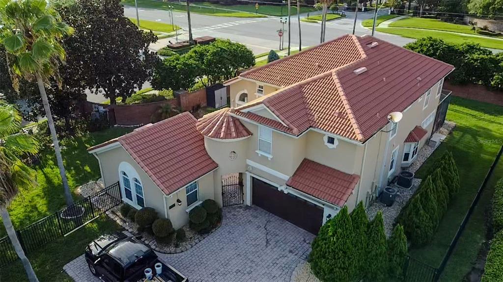 An aerial view of a two-story house with a red tile roof and paved driveway — 11434 RAPALLO LANE, WINDERMERE, FL