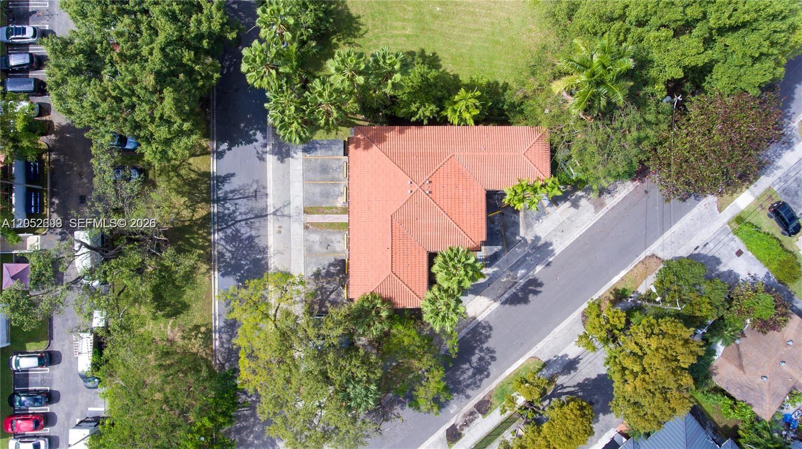 An aerial view shows a building with a red tile roof and surrounding parking lots — 1333 NW 15th St # 10, Miami FL 33125, MIAMI, FL