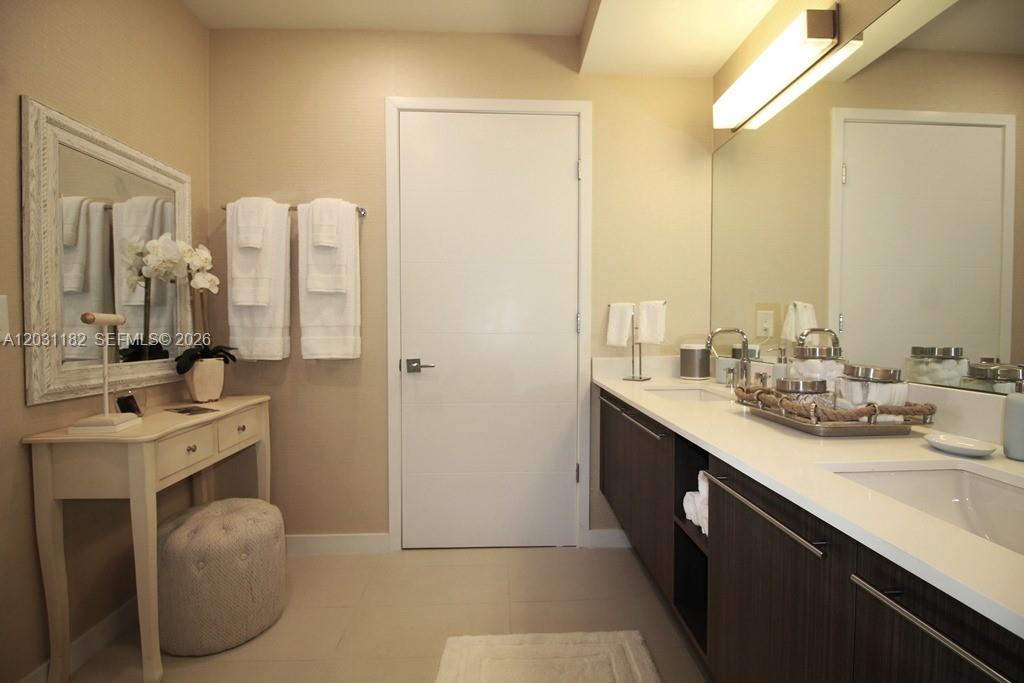 A modern bathroom features a double vanity, a white console table, and a central door — 7751 NW 107th Ave # 805, Doral FL 33178, DORAL, FL