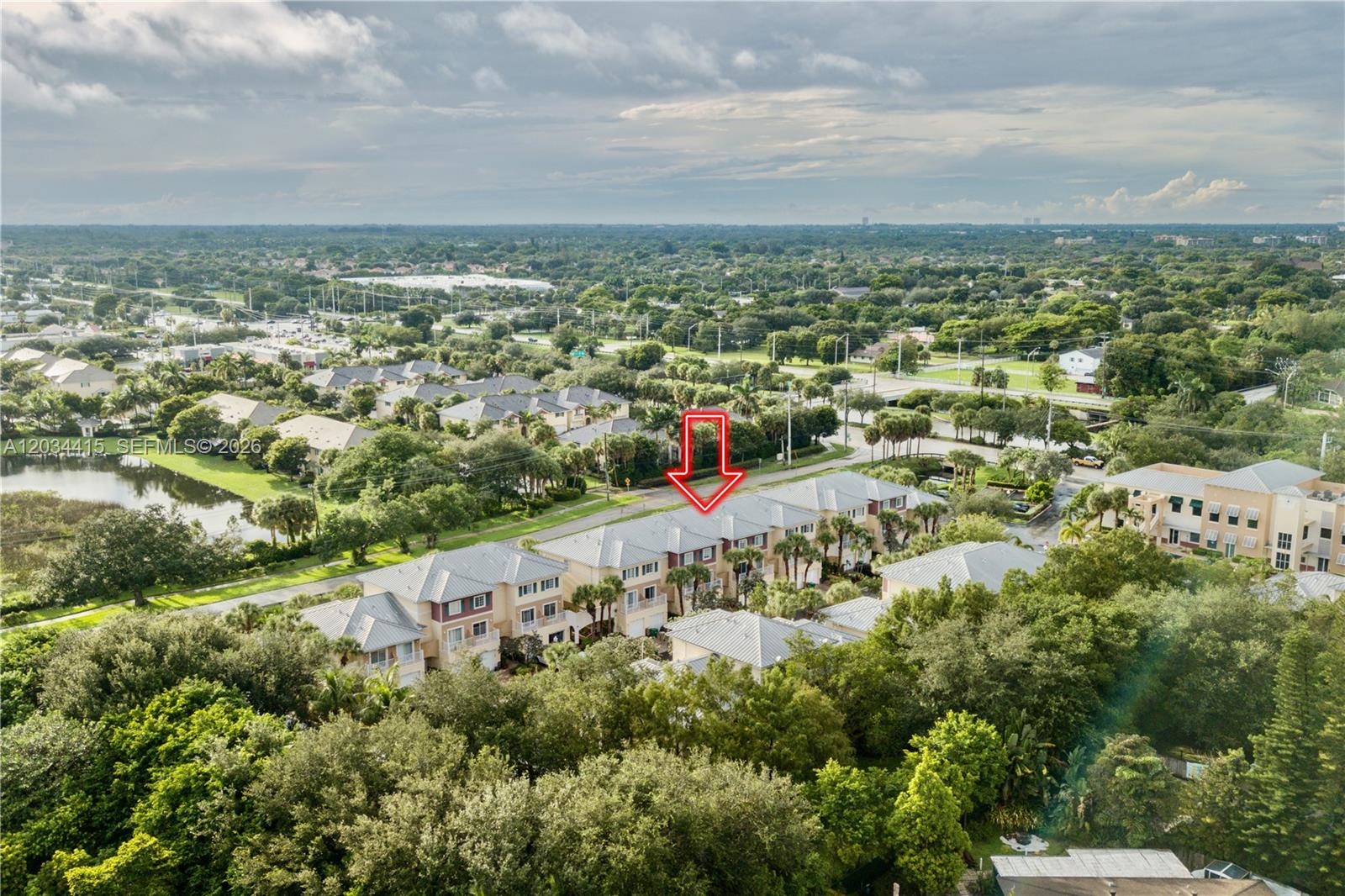 An aerial view shows a row of townhouses with a red arrow pointing downward — 4649 SW 75th Way, Davie FL 33314, DAVIE, FL