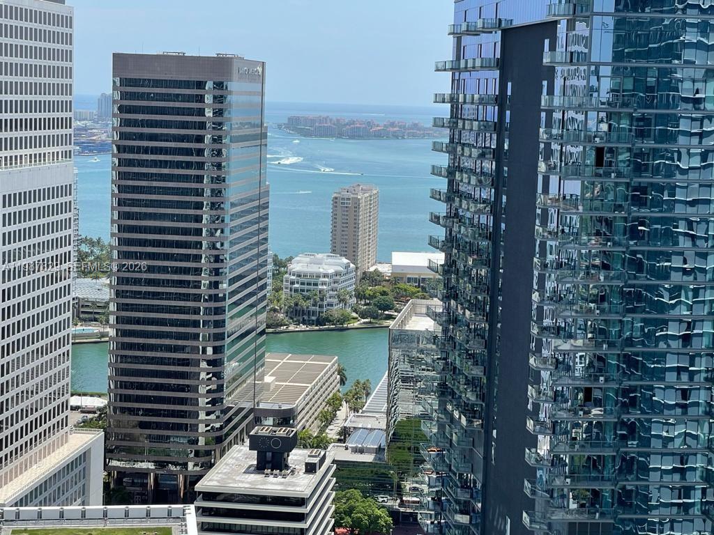 An elevated view of a city skyline featuring tall glass skyscrapers overlooking a bay — 88 SW 7th St # 3609, Miami FL 33130, MIAMI, FL