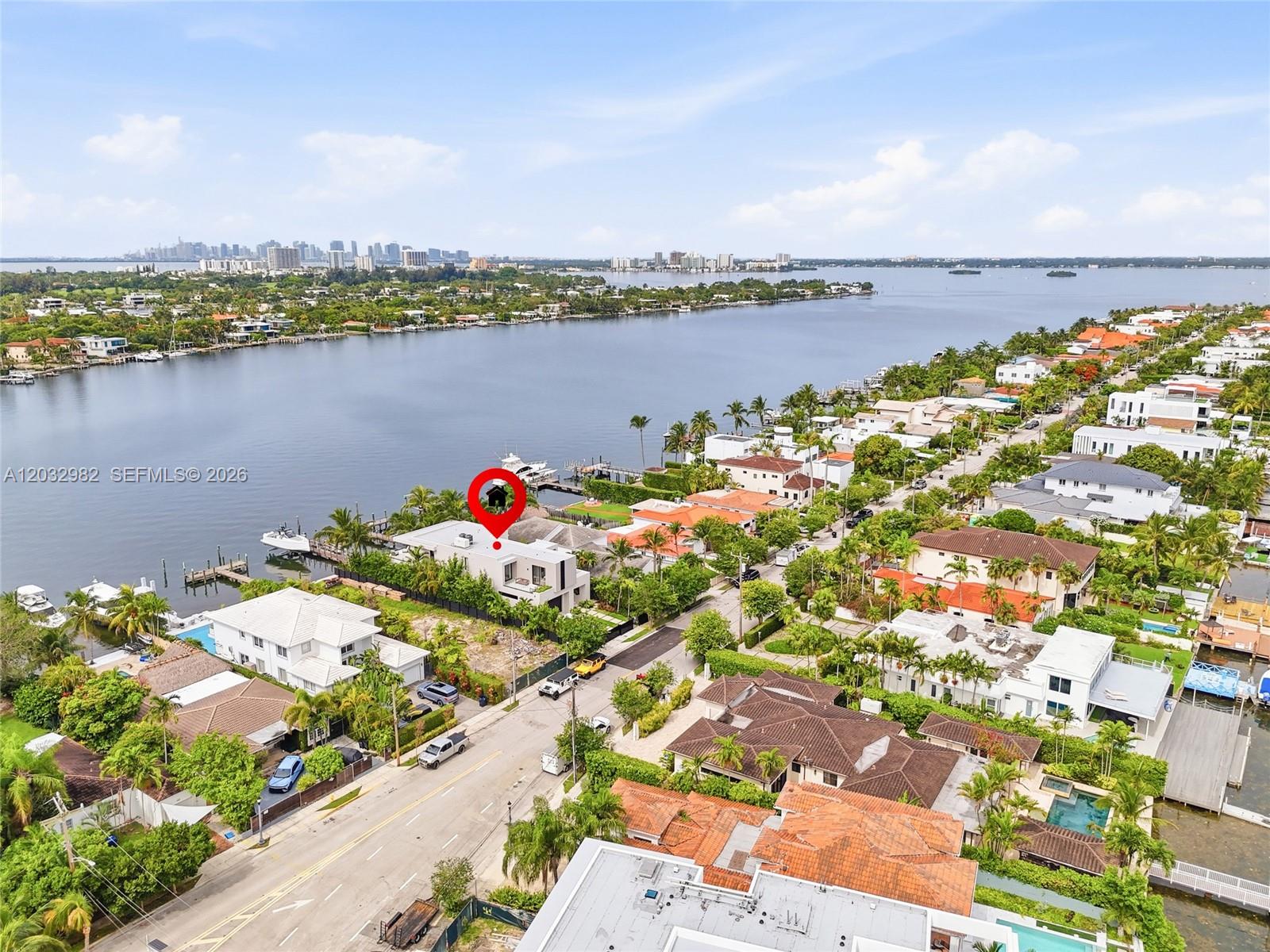 An aerial view shows a modern waterfront house with a private dock and pool — 1050 Stillwater Dr, Miami Beach FL 33141, MIAMI BEACH, FL