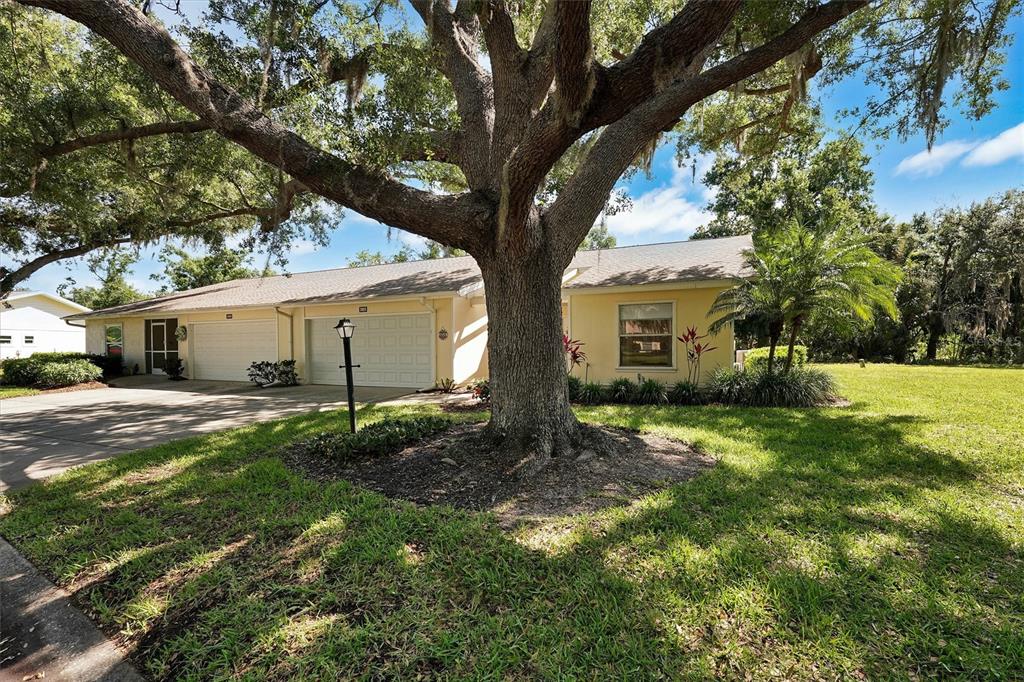 A single-story house with a yellow exterior, a two-car garage, and a covered front entryway — 3925 OAKHURST BOULEVARD, SARASOTA, FL