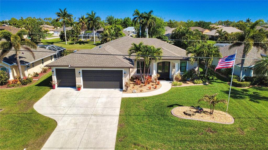An aerial view of a single-story suburban house with a gray roof and attached garage — 39 MEDALIST ROAD, ROTONDA WEST, FL