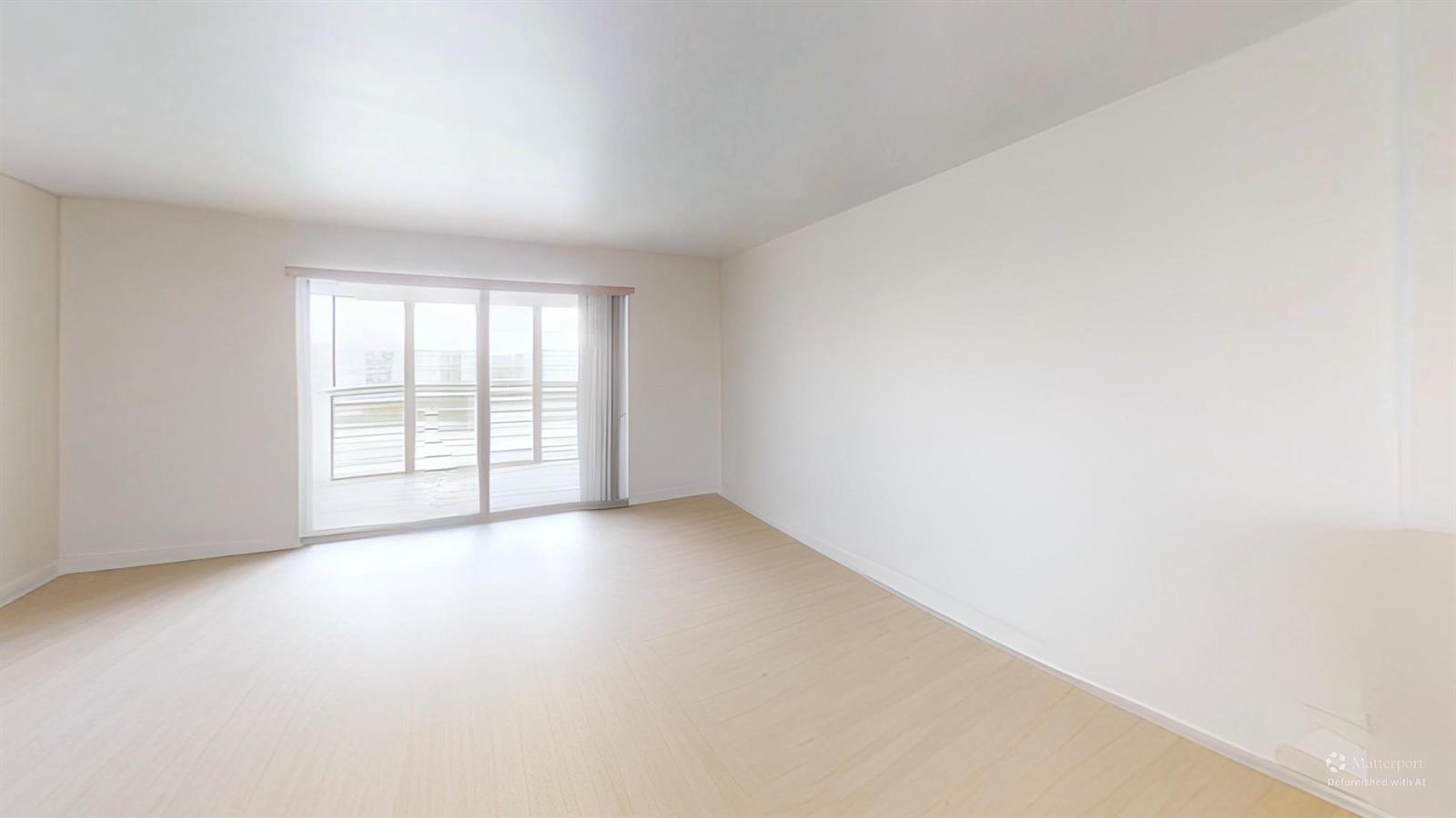 An empty room with light wood-look flooring, white walls, and a sliding glass balcony door — 101 SE 3rd Avenue # 605, Dania Beach FL 33004, DANIA BEACH, FL