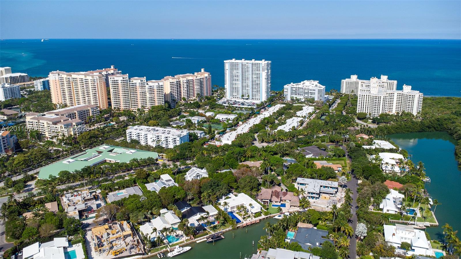 An aerial view shows a coastal neighborhood with high-rise buildings, lush trees, and waterways — 881 Ocean Dr # 7D, Key Biscayne FL 33149, KEY BISCAYNE, FL