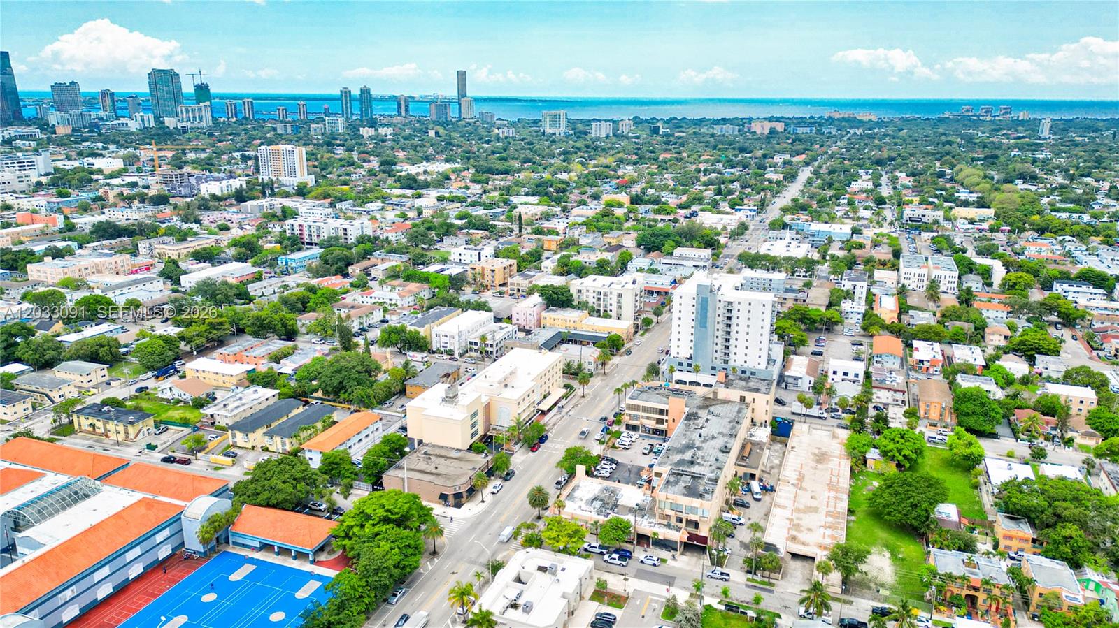 An aerial view shows a dense urban neighborhood with buildings, streets, and a blue sports court — 304 SW 12 Ave, Miami FL 33130, MIAMI, FL