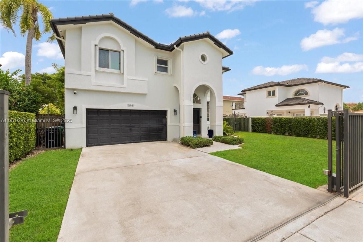 A two-story house with a white exterior, a black garage door, and a grassy lawn — 15931 SW 61st Ln, Miami FL 33193, MIAMI, FL