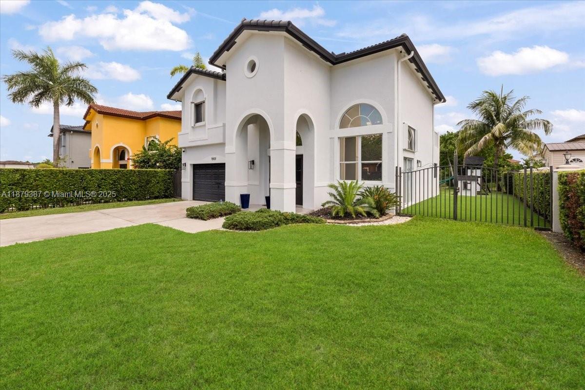 A two-story white house with a black garage door and a green lawn — 15931 SW 61st Ln, Miami FL 33193, MIAMI, FL