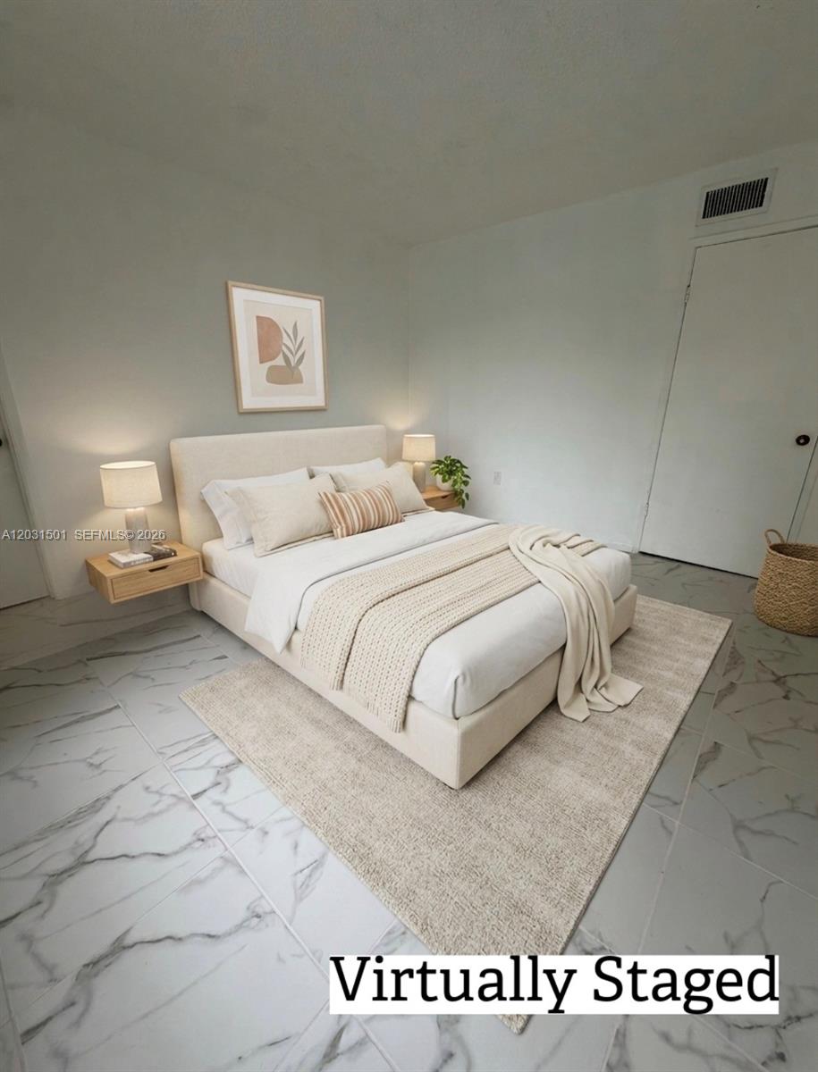 This virtually staged bedroom features a neutral bed, floating nightstands, and marble-patterned tile flooring — 13701 Kendale Lakes Cir # 308, Miami FL 33183, MIAMI, FL