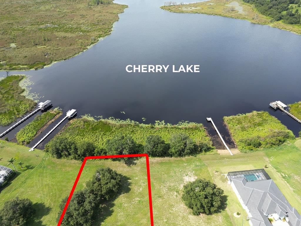 An aerial view shows a vacant lot bordering Cherry Lake with several private boat docks — ROYAL PALM DRIVE UNIT 15, GROVELAND, FL