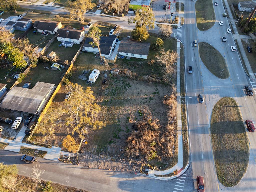 An aerial view shows a vacant lot situated between residential houses and a busy road — 2628 HERBISON DRIVE, ORLANDO, FL