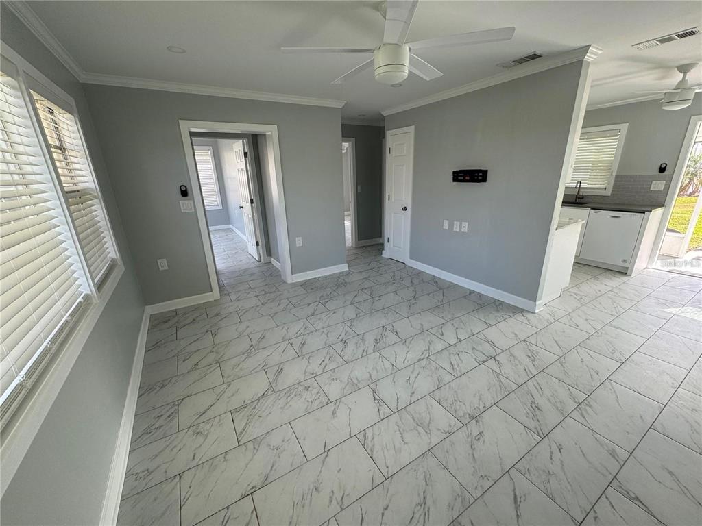 A room with gray walls, white trim, and white marble-patterned tile flooring — 301 COLONIA LANE W, NOKOMIS, FL