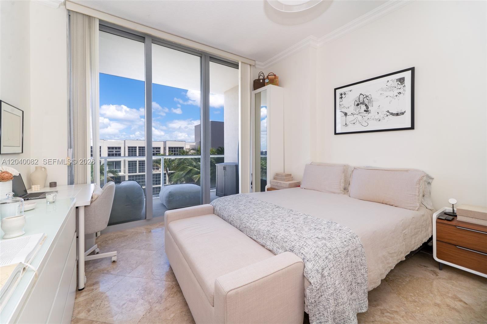 A bedroom features a bed with a bench, a desk, and a balcony with views — 3470 E Coast Ave # H1109, Miami FL 33137, MIAMI, FL