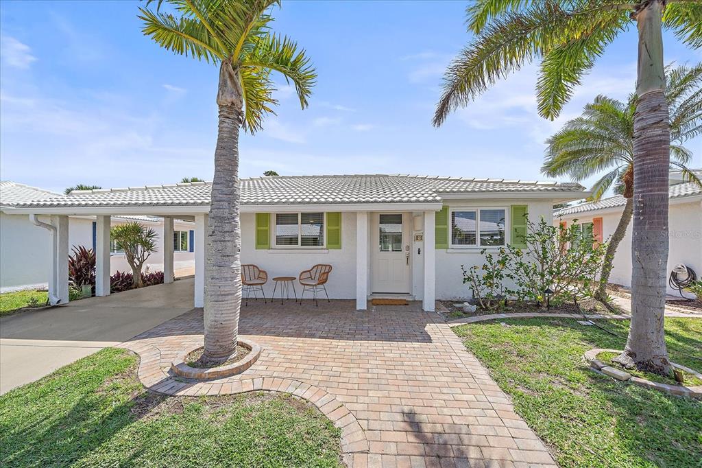 A single-story house with a brick walkway, palm trees, and a covered carport — 914 SPANISH DRIVE S UNIT 76, LONGBOAT KEY, FL