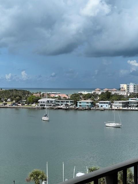 A view of a calm waterway with two sailboats and coastal buildings under a cloudy sky — 650 ISLAND WAY UNIT 708, CLEARWATER BEACH, FL