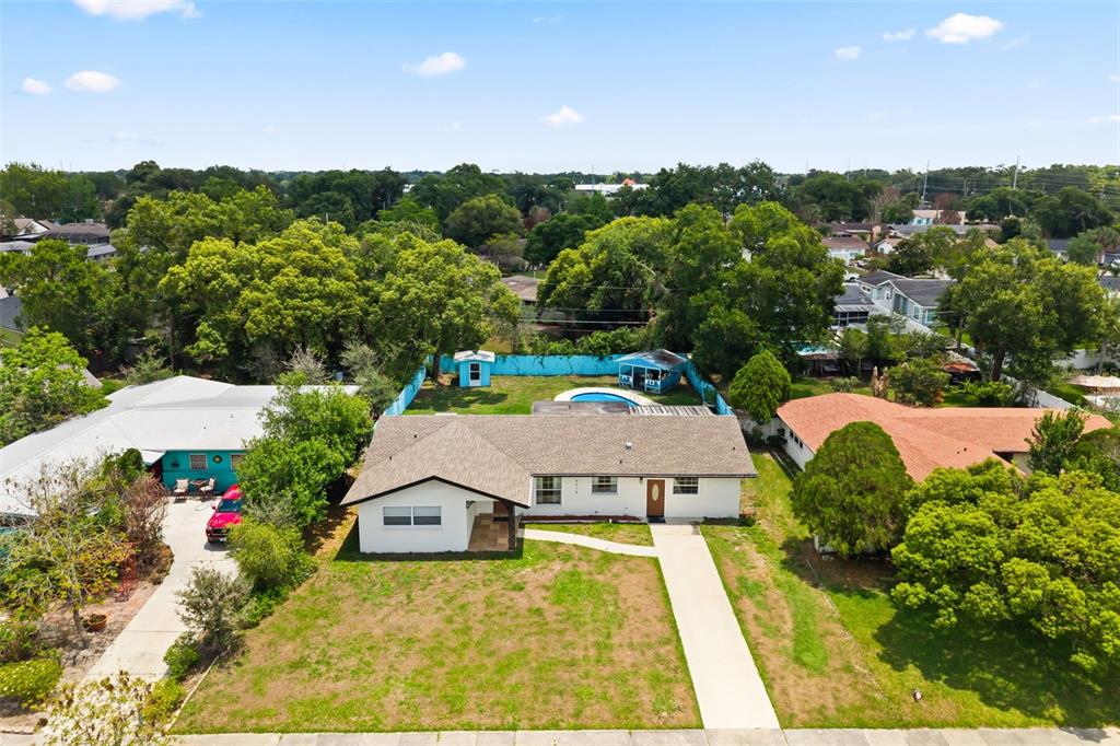 An aerial view shows a single-story house with a pool, fenced backyard, and driveway — 4515 BRADLEY AVENUE, ORLANDO, FL